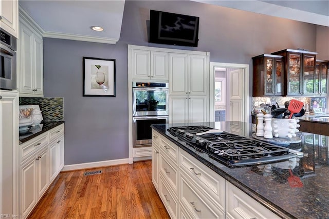 103 Acacia Ct, Williamsburg, VA 23185 - kitchen featuring black gas cooktop, double oven, decorative backsplash, light wood-type flooring, and dark stone counters