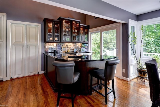 103 Acacia Ct, Williamsburg, VA 23185 - indoor wet bar with wood finished floors, decorative backsplash, and baseboards