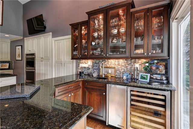 103 Acacia Ct, Williamsburg, VA 23185 - bar area featuring wine cooler, a sink, decorative backsplash, stainless steel double oven, and refrigerator