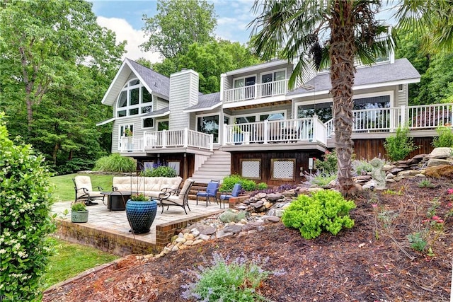 103 Acacia Ct, Williamsburg, VA 23185 - rear view of property featuring outdoor lounge area, a patio, a wooden deck, stairs, and a balcony