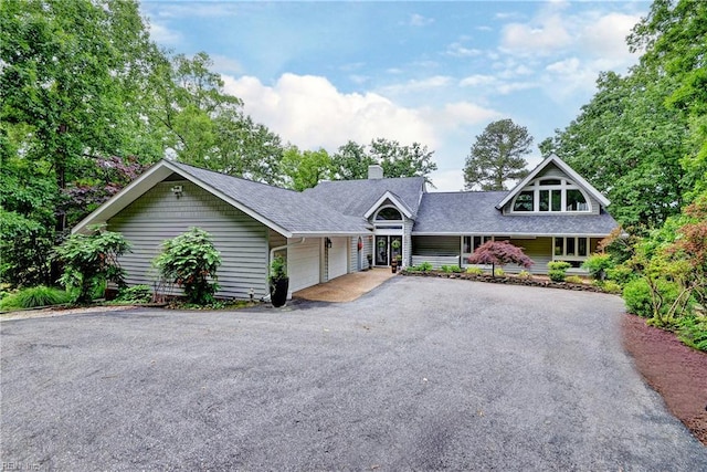 103 Acacia Ct, Williamsburg, VA 23185 - view of front of house with a garage, asphalt driveway, a chimney, and a shingled roof