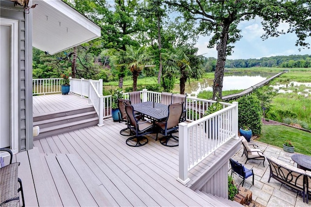 103 Acacia Ct, Williamsburg, VA 23185 - deck with outdoor dining area, a water view, view of scattered trees, and a patio area