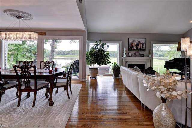 103 Acacia Ct, Williamsburg, VA 23185 - dining area with a chandelier, wood finished floors, healthy amount of natural light, and a fireplace
