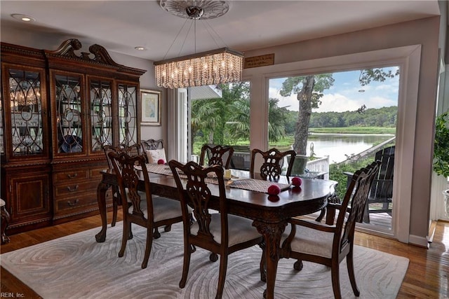 103 Acacia Ct, Williamsburg, VA 23185 - dining room featuring a chandelier, a water view, recessed lighting, and wood finished floors