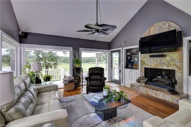 103 Acacia Ct, Williamsburg, VA 23185 - living room featuring wood finished floors, a fireplace, a ceiling fan, and high vaulted ceiling