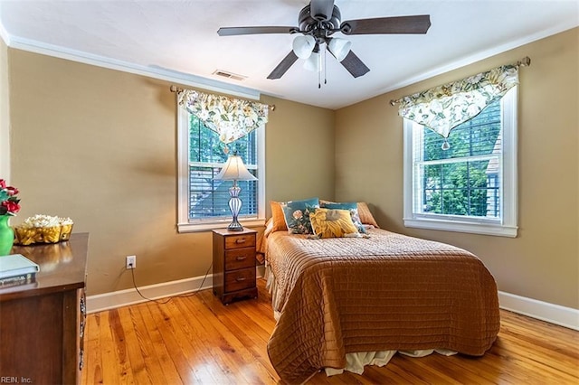 200 Ferguson Ave, Newport News, VA 23601 - bedroom with multiple windows, light wood-style floors, baseboards, and a ceiling fan