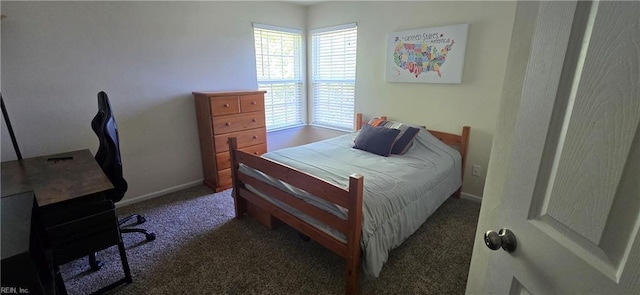 carpeted bedroom featuring baseboards