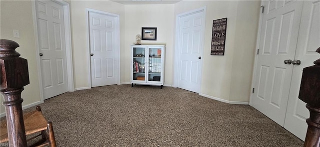 unfurnished bedroom with carpet flooring and baseboards