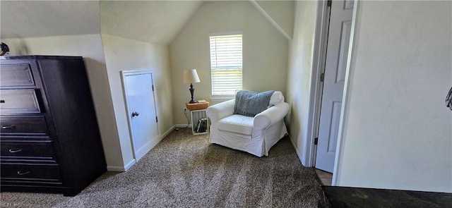 living area with carpet floors, vaulted ceiling, and baseboards