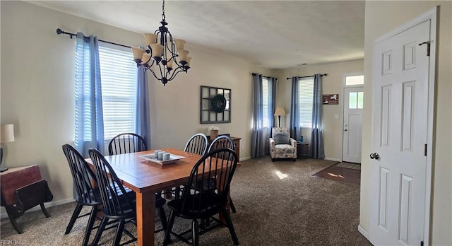 dining room featuring carpet flooring, a chandelier, and baseboards