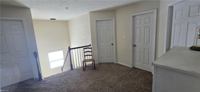 corridor featuring carpet floors and an upstairs landing