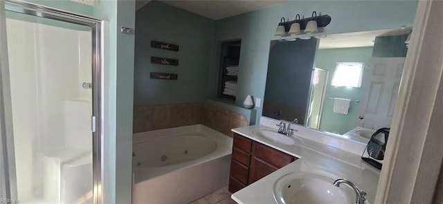 bathroom with a stall shower, a whirlpool tub, double vanity, and tile patterned floors