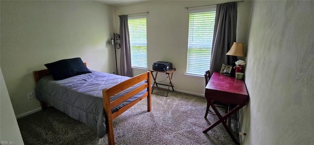 bedroom featuring carpet flooring, multiple windows, and baseboards