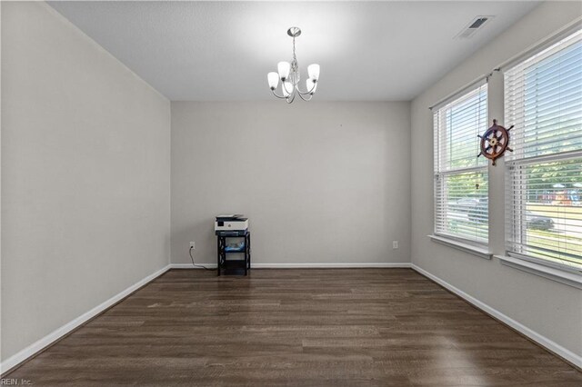3001 Ravine Gap Dr, Suffolk, VA 23434 - spare room with a chandelier, dark wood-style floors, and baseboards