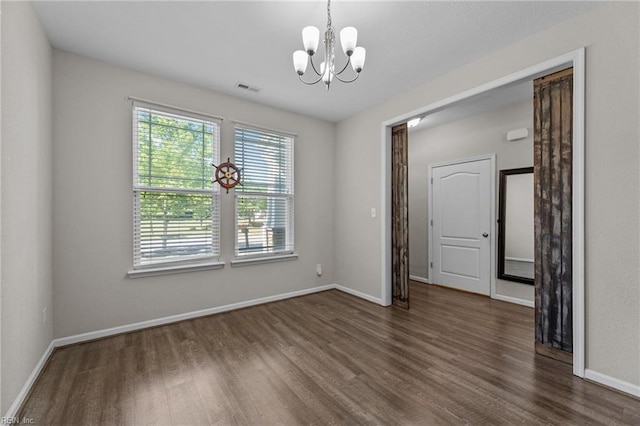 3001 Ravine Gap Dr, Suffolk, VA 23434 - unfurnished room featuring dark wood-style flooring, a chandelier, and baseboards