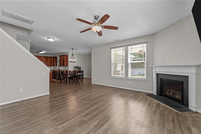 3001 Ravine Gap Dr, Suffolk, VA 23434 - living room featuring ceiling fan, dark wood-style floors, a fireplace with raised hearth, and baseboards