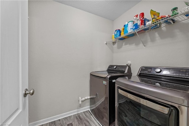 3001 Ravine Gap Dr, Suffolk, VA 23434 - laundry area with washing machine and clothes dryer, wood finished floors, and baseboards
