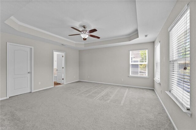 3001 Ravine Gap Dr, Suffolk, VA 23434 - unfurnished room featuring a raised ceiling, carpet, ceiling fan, crown molding, and baseboards
