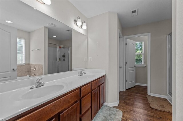 3001 Ravine Gap Dr, Suffolk, VA 23434 - full bathroom with wood finished floors, a stall shower, double vanity, and baseboards