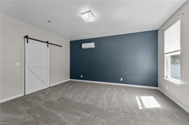 3001 Ravine Gap Dr, Suffolk, VA 23434 - unfurnished bedroom with a barn door, carpet, a wall unit AC, and baseboards