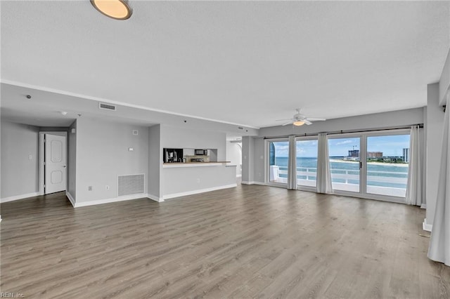 3556 Shore Dr Unit 704, Virginia Beach, VA 23455 - unfurnished living room featuring a ceiling fan, baseboards, and wood finished floors