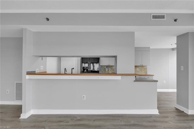 3556 Shore Dr Unit 704, Virginia Beach, VA 23455 - kitchen featuring wood finished floors, tasteful backsplash, baseboards, crown molding, and a textured ceiling