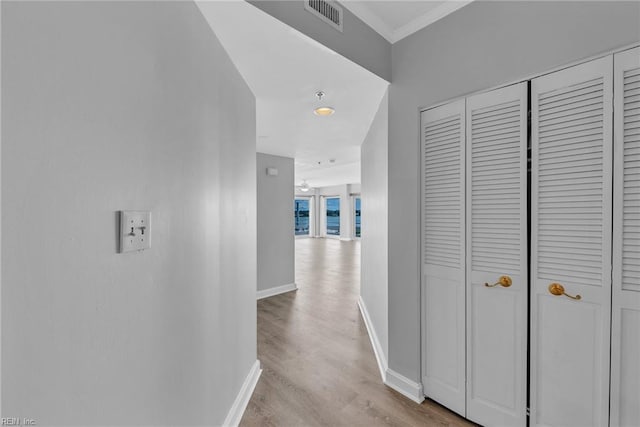 3556 Shore Dr Unit 704, Virginia Beach, VA 23455 - hallway with baseboards, light wood finished floors, and crown molding