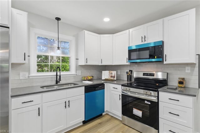 4009 Forresthills Dr, Portsmouth, VA 23703 - kitchen with appliances with stainless steel finishes, a sink, light wood-style flooring, white cabinetry, and recessed lighting