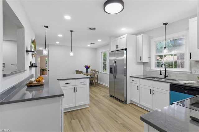 4009 Forresthills Dr, Portsmouth, VA 23703 - kitchen featuring stainless steel fridge with ice dispenser, a sink, light wood-type flooring, white cabinets, and recessed lighting
