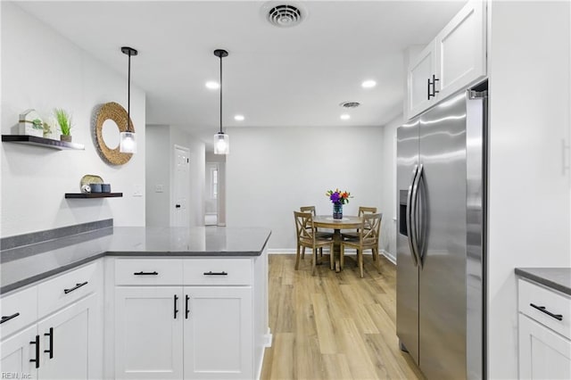 4009 Forresthills Dr, Portsmouth, VA 23703 - kitchen with stainless steel fridge with ice dispenser, light wood-type flooring, white cabinetry, open shelves, and a peninsula