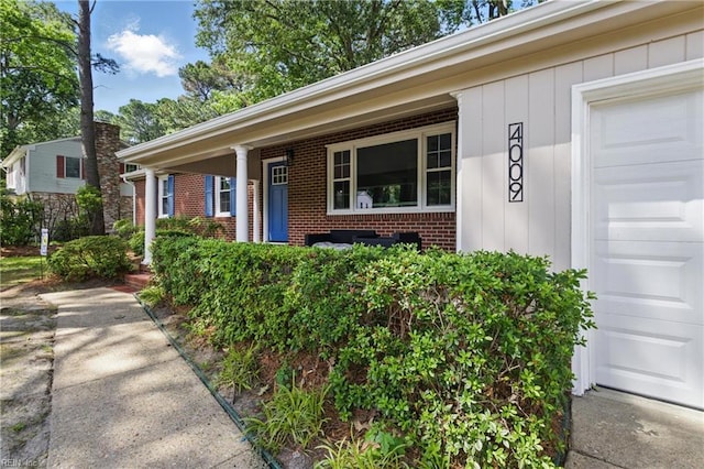 4009 Forresthills Dr, Portsmouth, VA 23703 - property entrance with brick siding, covered porch, and a garage