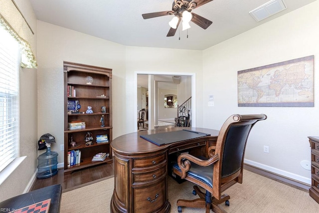 home office featuring ceiling fan, wood finished floors, and baseboards