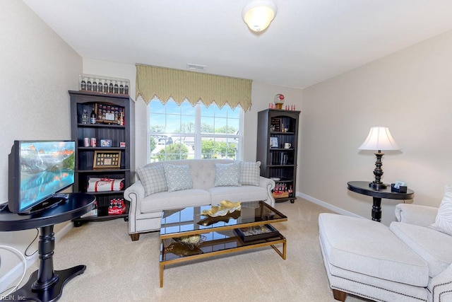 carpeted living area featuring baseboards