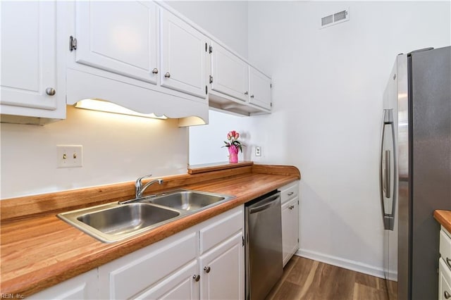 443 Peregrine St, Virginia Beach, VA 23462 - kitchen with appliances with stainless steel finishes, a sink, dark wood-style flooring, white cabinets, and baseboards