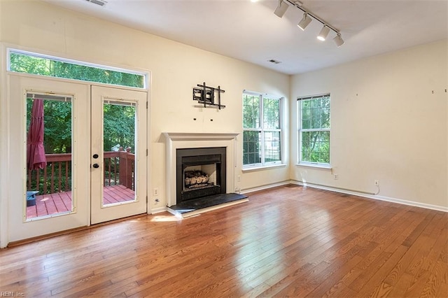 1209 Willow Creek Ct, Chesapeake, VA 23321 - unfurnished living room with rail lighting, wood-type flooring, and plenty of natural light