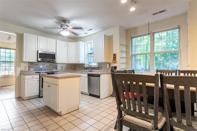 1209 Willow Creek Ct, Chesapeake, VA 23321 - kitchen with stainless steel appliances, white cabinetry, backsplash, light countertops, and ceiling fan