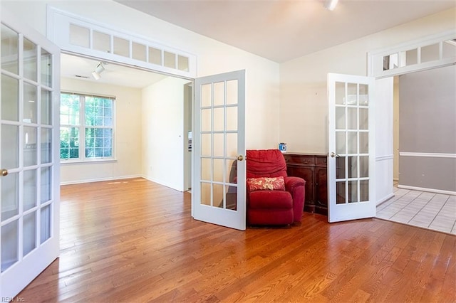 1209 Willow Creek Ct, Chesapeake, VA 23321 - living area with french doors, wood finished floors, and baseboards