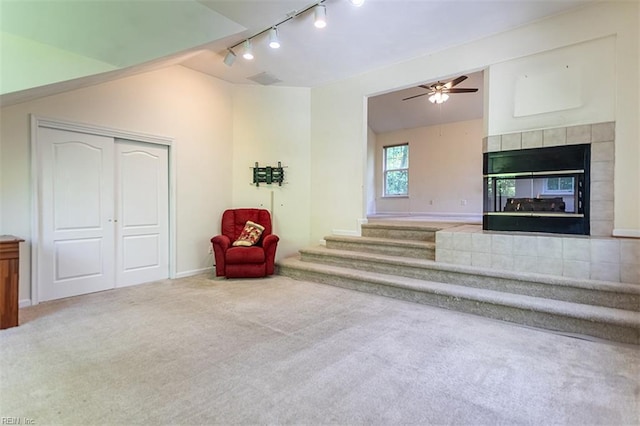 1209 Willow Creek Ct, Chesapeake, VA 23321 - unfurnished living room with rail lighting, vaulted ceiling, carpet flooring, ceiling fan, and a fireplace