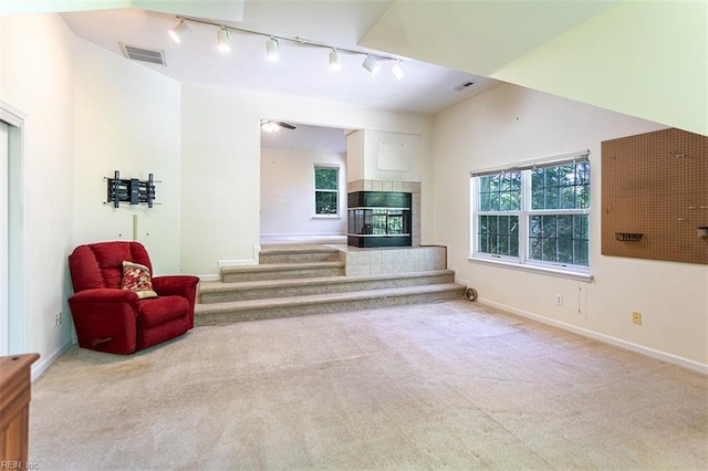 1209 Willow Creek Ct, Chesapeake, VA 23321 - carpeted living room with rail lighting, stairway, baseboards, and healthy amount of natural light