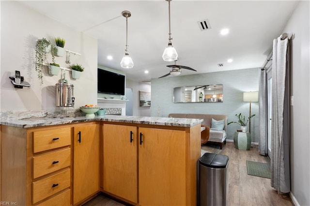 164 Nottingham Trl, Newport News, VA 23602 - kitchen featuring wood finished floors, a ceiling fan, light stone counters, hanging light fixtures, and open floor plan