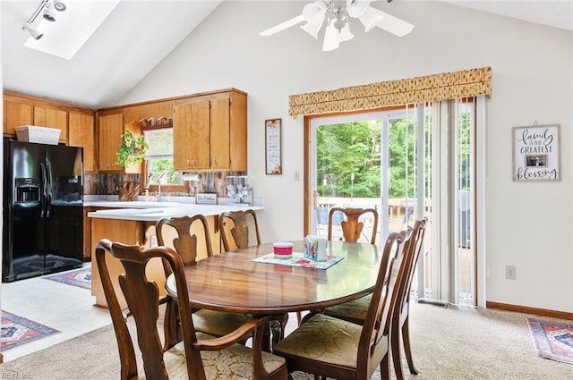 3408 Waterview Rd, Toano, VA 23168 - dining space with plenty of natural light, a skylight, a ceiling fan, light carpet, and high vaulted ceiling