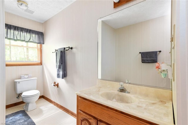 3408 Waterview Rd, Toano, VA 23168 - half bath featuring vanity, toilet, baseboards, and a textured ceiling