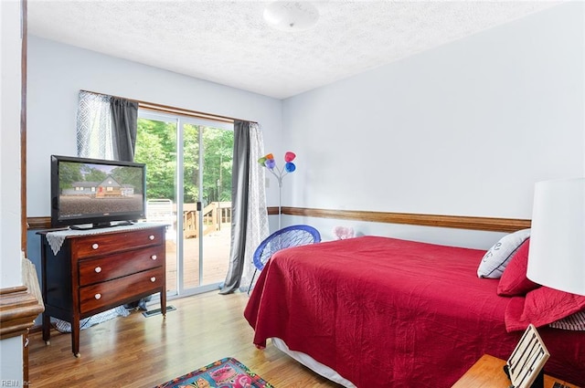 3408 Waterview Rd, Toano, VA 23168 - bedroom with access to outside, wood finished floors, and a textured ceiling