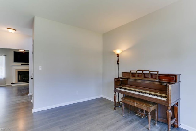 2825 Ridgeboard Pl, Chesapeake, VA 23323 - sitting room with wood finished floors, baseboards, and a fireplace with raised hearth