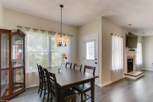 2825 Ridgeboard Pl, Chesapeake, VA 23323 - dining area featuring dark wood-style floors, a chandelier, baseboards, and a fireplace with raised hearth