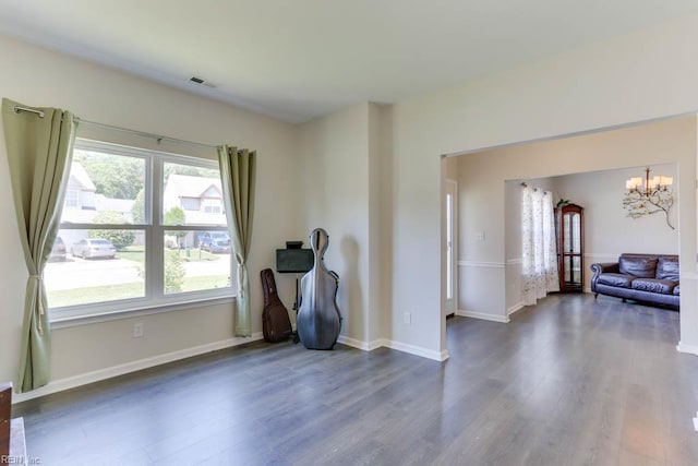 2825 Ridgeboard Pl, Chesapeake, VA 23323 - empty room featuring dark wood-type flooring, a chandelier, and baseboards
