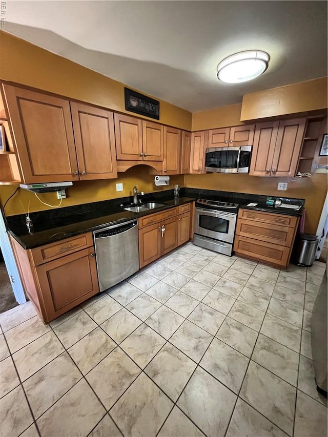 5113 Stratford Chase Dr, Virginia Beach, VA 23464 - kitchen featuring stainless steel appliances, a sink, brown cabinetry, and dark countertops