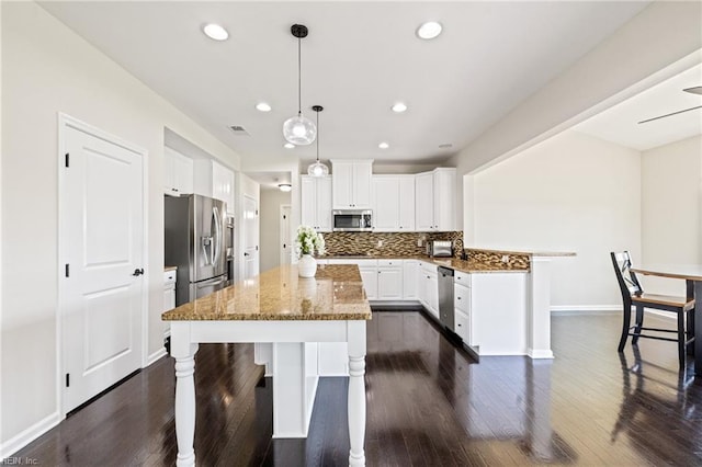 1925 Dale Greene Pl, Virginia Beach, VA 23456 - kitchen featuring stainless steel appliances, a kitchen bar, dark wood-type flooring, dark stone countertops, and recessed lighting