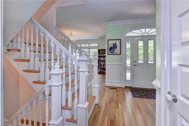 117 Shinnecock, Williamsburg, VA 23188 - foyer entrance with stairs, wood finished floors, a wainscoted wall, a chandelier, and a decorative wall