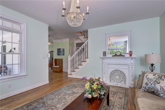 117 Shinnecock, Williamsburg, VA 23188 - living area with a chandelier, wood finished floors, stairway, and baseboards